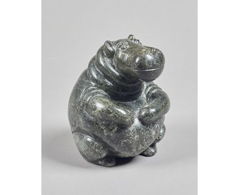 A Zimbabwean polished opal seated hippo, unsigned, 21cm high. Illustrated. 