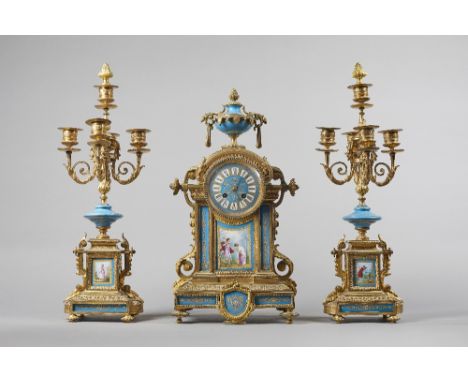 A Napoleon III ormolu and porcelain clock garnitureCirca 1865The clock surmounted by an urn above an arched pediment  on a st