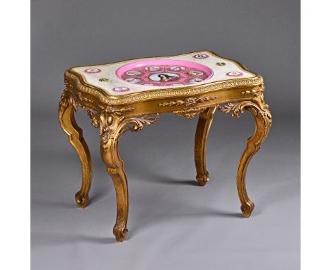 A 19th century French gilt salon table, the serpentine rectangular top inset with Sevres style ceramic plaques, depicting Lou
