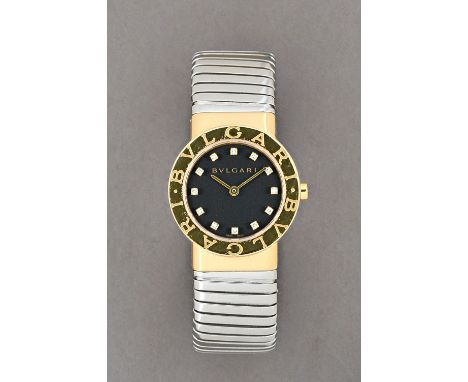 A Bvlgari diamond set, gold and steel lady's bangle wristwatch, the signed black dial with diamond set numerals and with plai
