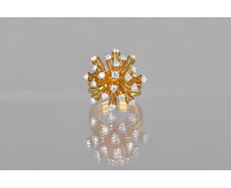 A gold and diamond set ring, in an abstract starburst shaped design, detailed 750 18 K, ring size N, gross weight 12.6 gms, w