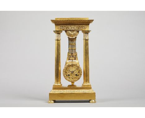 A French Empire ormolu portico clock By Humbert A Metz, circa 1820Of narrow proportion, the entablature cast with two pelican