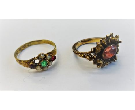 A gold filigree and oval cut foil backed orange gem set single stone ring, in a canatille work design, ring size G and a half