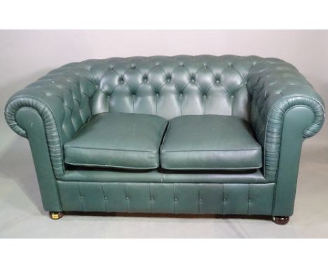 A 20th century Chesterfield sofa with green leather button back upholstery on bun feet, 160cm wide. 