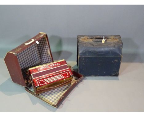 An early 20th century cased accordion and another, (2). 