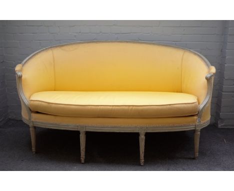 A Louis XVI style tub back sofa, with cream painted moulded frame, on tapering fluted supports, 180cm wide x 98cm high. 