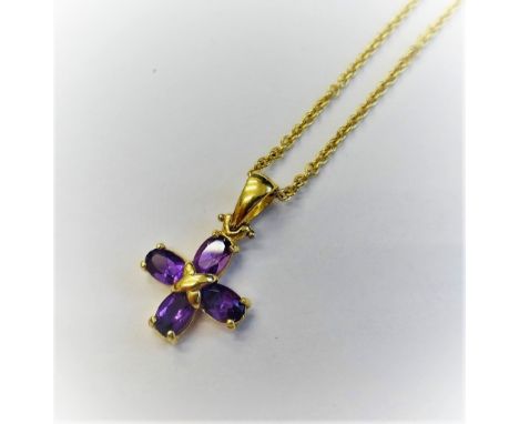 A gold and amethyst four stone pendant, mounted with oval cut amethysts, detailed 750 CRISO, with a gold oval link neckchain,