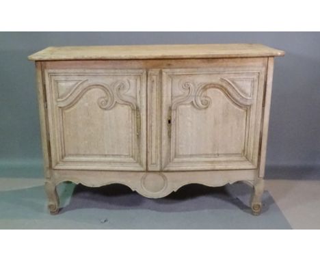 A French oak side cabinet with inset carved panel doors, 140cm wide x 90cm high. 