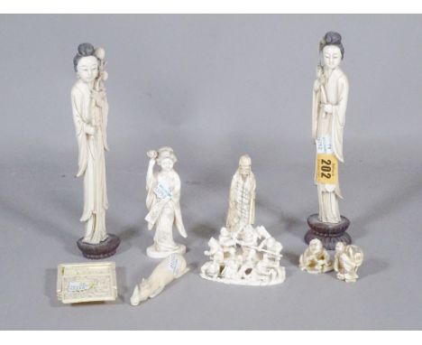 A group of mainly 19th century Asian ivory items including a Canton carved ivory puzzle, Japanese and Chinese figures and sun