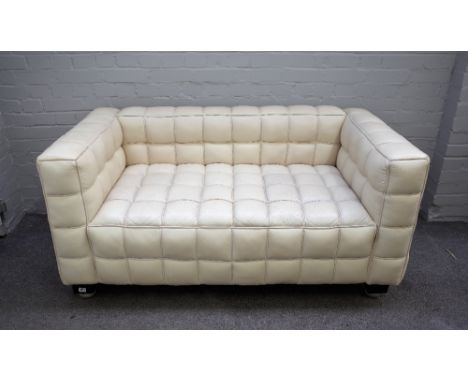 A 20th century cream leather square back sofa with piped cube pattern upholstery on ebonised bracket feet, 150cm wide x 72cm 