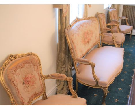 A Fine French 19th Century Salon Suite. Circa 1800. Comprising a two seater couch and four open armchairs. With giltwood fram