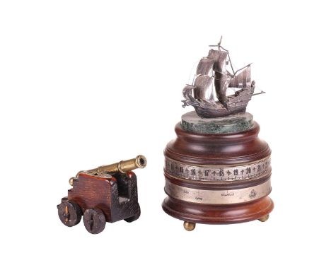 A 19th-century miniature naval cannon with a tapering girdled body on a stepped oak carriage with pegged wooden wheels, 16 cm