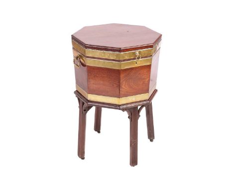 A George III Chippendale Period brass-bound mahogany octagonal cellaret with moulded edge, the hinged top opening to reveal t