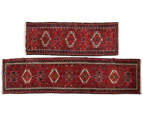A red ground Karaja strip runner with nice lozenges on a central pole, within multiple borders, 295cm x 70 cm, together with 