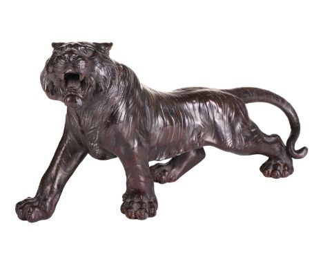 After Seiya, a Japanese bronze patinated spelter figure of a stalking tiger, early 20th century, unmarked. . 37 cm long,A pri