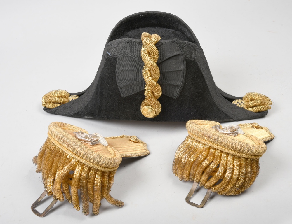 A Victorian Naval Officers cocked hat with gilt braid and epaulettes ...