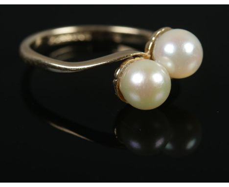 A 9ct Gold and Pearl 'Moi et Toi' ring. Size KÂ½. Total weight: 1.9g.  