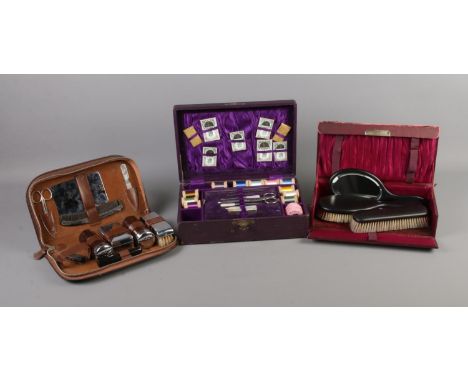 A sewing kit featuring mother of pearl tools, boxed Ebony vanity set and vintage gents grooming kit in leather case.  