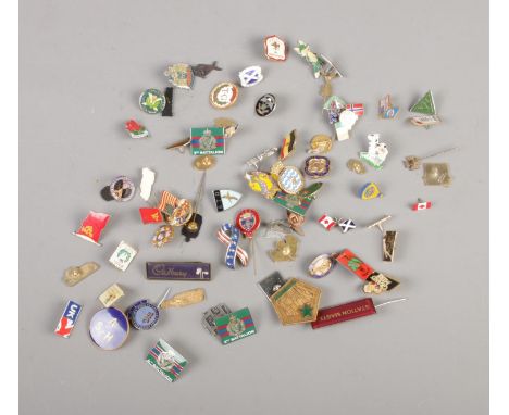 A collection of assorted vintage pin badges including Cadbury, Aubert, Station Master, Scotland Forever, etc. Approx. 60 badg