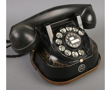 A Belgique Bell Telephone by MFG Company with rotary dial and gilt decoration.  