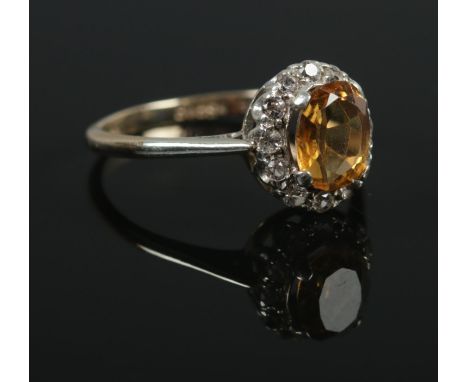 A 9ct Gold and yellow and white paste halo ring. Size O. Total weight: 2.1g  