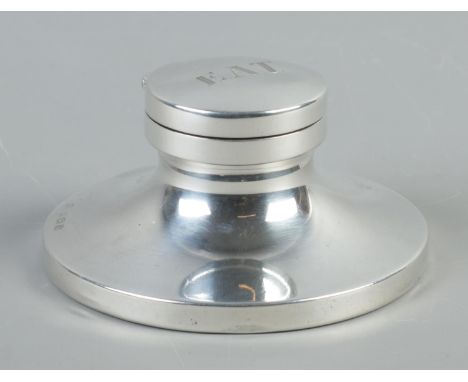 A silver capstan inkwell, with black base. Monogram to top of lid E.A.T. Assayed for Birmingham, 1913 with makers initials W.