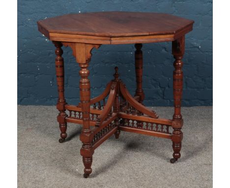 An octagonal window table, on bobbin and galleried stretcher, raised on casters. Height: 74cm, Diameter: 75cm.  Split to top.