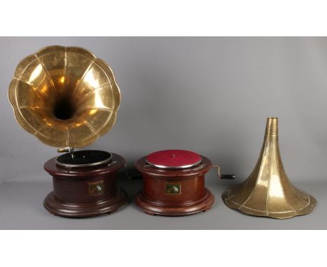 Two Vintage 'His Masters Voice' wooden gramophones on circular bases. Both with brass funnels, one with metal arm and needle.