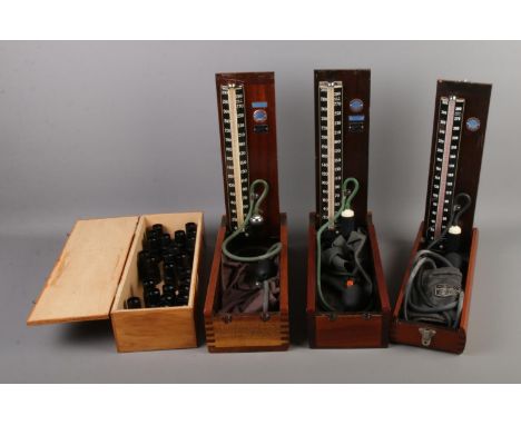Three vintage Accoson cased blood pressure monitors including two hospital models along with box of magnification lenses.  