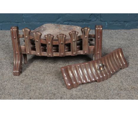 A cast iron fire basket and grate.  