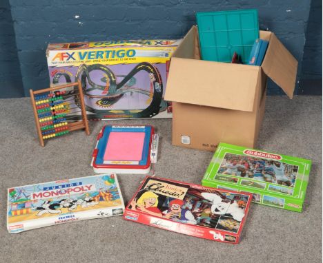 A box of mostly vintage board games. Including Junior Monopoly, Connect 4, Subbuteo, Tomy AFX Vertigo racing set etc.  