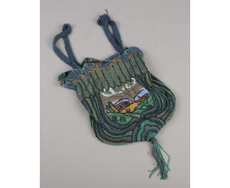 A vintage beadwork bag with detailed decoration depicting a desert scene.  Lining very worn. Fraying to handles. Some beadwor
