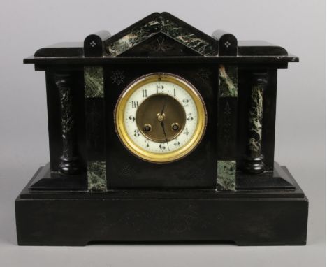 A black slate and marble mantle clock, with Arabic numeral dial. 31cm high.  