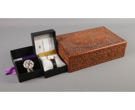 A carved jewellery box with contents of collectables. To include ingersoll pocket watch, boxed quartz wristwatches, Old St An