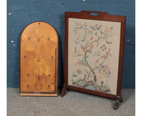 A oak framed embroided fire screen along with a Corinthian bagatelle board.  
