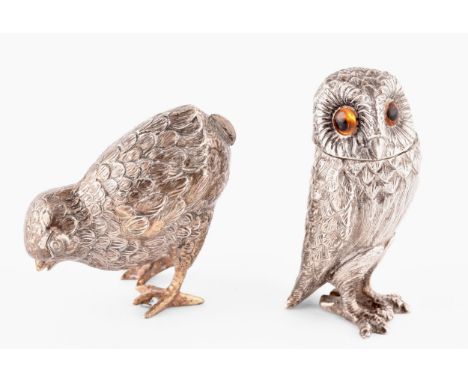 A silver owl pepperette and a silver bird bird holder, owl has orange stone eyes and a detachable head, bird has opening to r