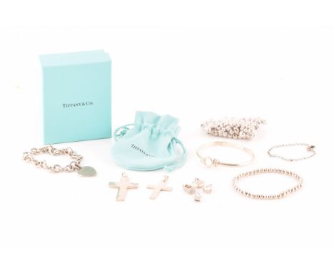 A Tiffany & Co silver bracelet with heart charm, length 18 cm, in original pouch and box, together with a silver knot bangle,
