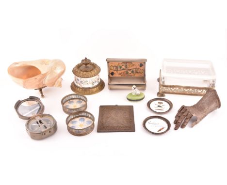 A collection of decorative objects including a mother-of-pearl conch shell, a pair of silver pin trays, a iron miniature gaun