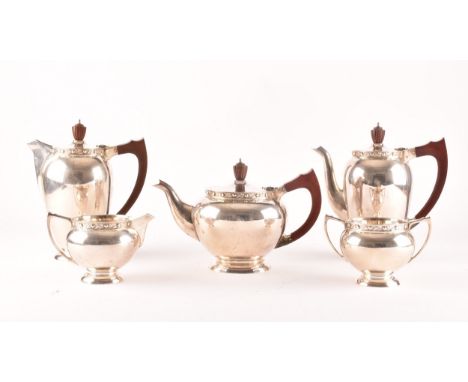 A Elizabeth II five piece Garrard &amp; Co silver tea and coffee set, including a tea pot, coffee pot, hot water jug with woo