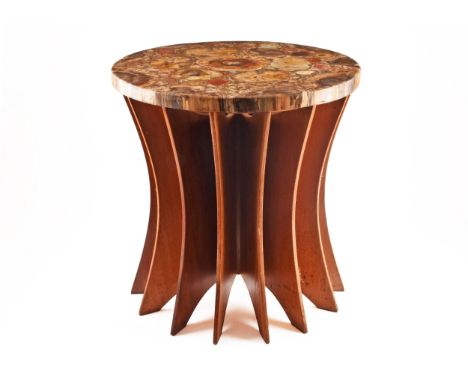 A fossilised wood side table designed by Marius Mosley (1976-), created out of a two hundred and fifty million years old petr