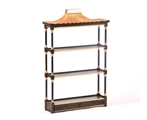 A 20th century oriental design black and gilt wall shelf, the top with pergoda style pediment, three shelves with column supp