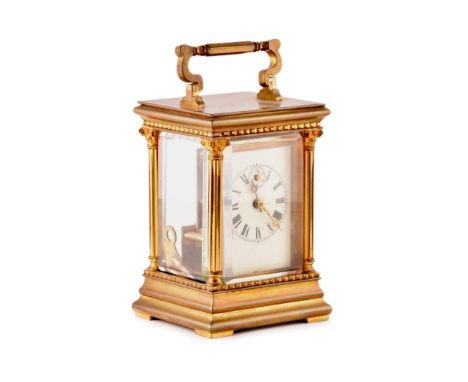 A late 19th/early 20th century ormolu carriage clock, white enamel dial with subsidiary&nbsp;seconds dial, the case with carr