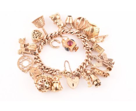 A 9ct rose gold curb link charm bracelet, suspended with a vast collection of 9ct yellow gold charms, including a Westminster