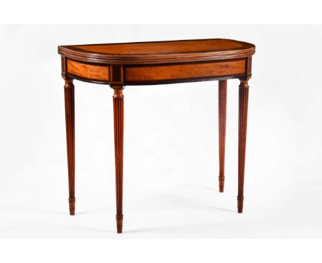 A Regency satinwood fold over card table, with rosewood cross banding, blue baize lined interior and supported on fluted tape