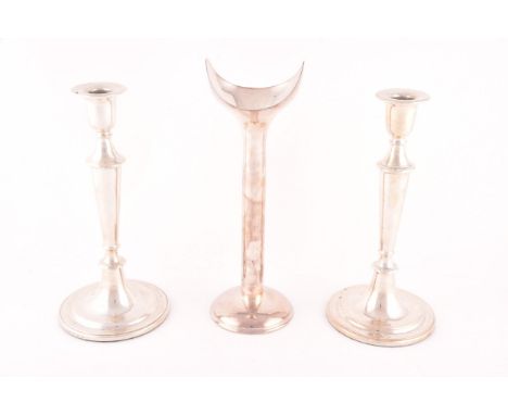 Three silver candlestick holders, all marked 925, pair measure 25.cm length, the third 28 cm length. (3)