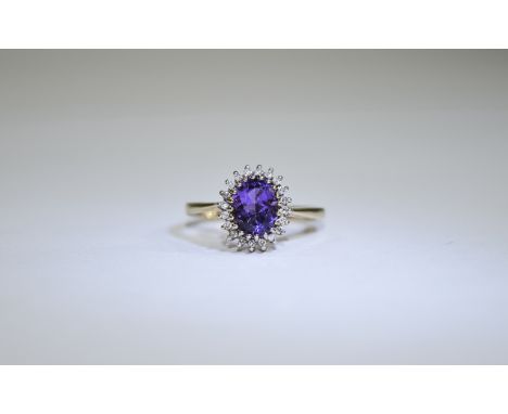 9ct Gold Amythist and Diamond Cluster Ring central oval amethyst surround by round cut diamonds. Fully hallmarked.