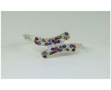 Multi Gemstone Crossover Bangle, set with fire opal, amethyst, sky blue topaz, peridot, rhodolite garnet and red garnet, tanz