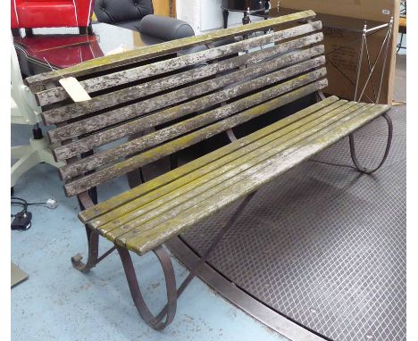 CRICKET BENCH, Early 20th Century wrought iron with weathered slat seats, 183cm W.