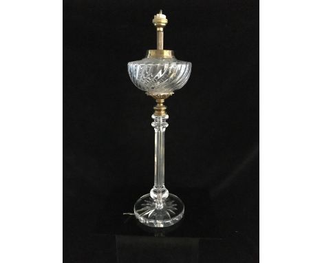 A gilt metal mounted cut glass lamp base, the hemispherical well on column stem and star cut circular foot, fitted for electr