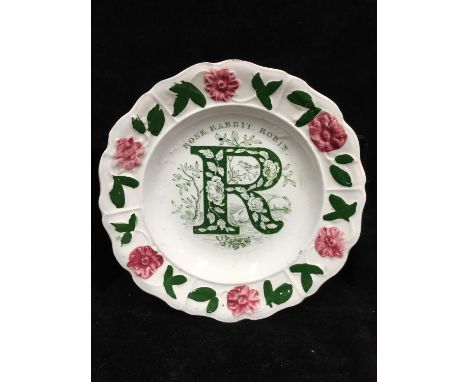 A Victorian pottery child's alphabet plate, printed in green with R and Rose, Rabbit, Robin within a moulded border of daisie